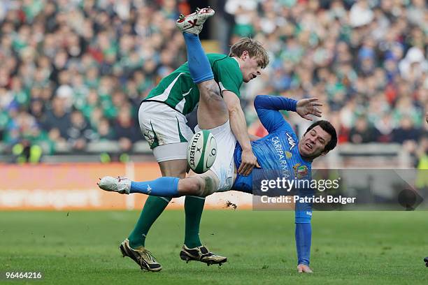 Craig Gower of Italy is tackled by Andrew Trimble of Ireland during the RBS Six Nations match between Ireland and Italy at Croke Park on February 6,...