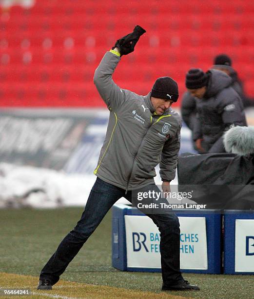 Head Coach Karsten Baumann of Osnabrueck throws away his glove during the third league match between FC Ingolstadt 04 and VfL Osnabrueck at the...