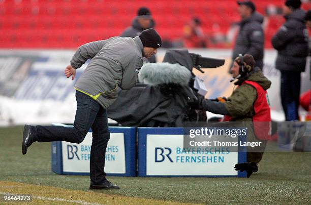 Head Coach Karsten Baumann of Osnabrueck throws away his glove during the third league match between FC Ingolstadt 04 and VfL Osnabrueck at the...