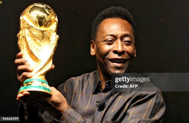 Brazilian football star Pele displays the FIFA World Cup during its presentation in Rio de Janeiro, Brazil on February 6, 2010. The cup is being...