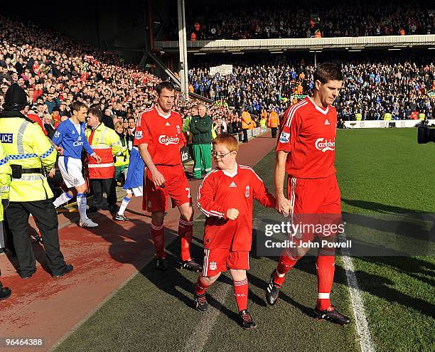 Steven Gerrard captian of Liverpool leads his team out during the Barclays Premier League match between Liverpool and Everton at Anfield on February...