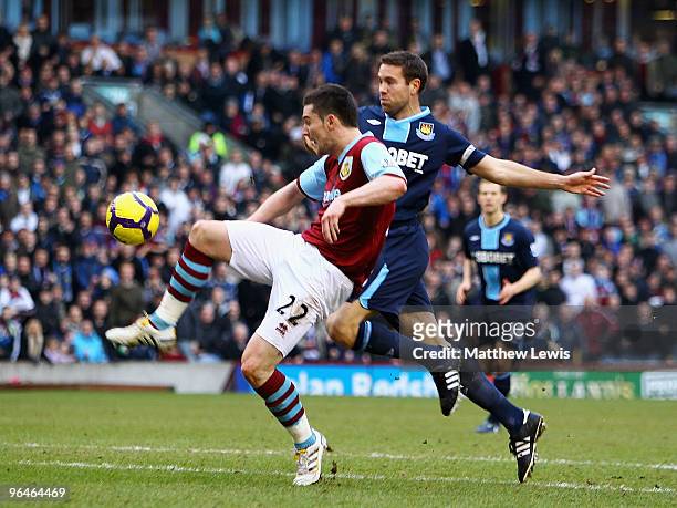 David Nugent of Burnley beats Matthew Upson of West Ham to score a goal during the Barclays Premier League match between Burnley and West Ham United...