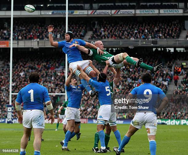 Carlo Del Fava of Italy misses the ball as Paul O'Connell of Ireland takes a tumble during the RBS Six Nations match between Ireland and Italy at...