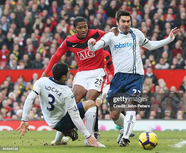 Antonio Valencia of Manchester United clashes with Ricardo Rocha and Richard Hughes of Portsmouth during the FA Barclays Premier League match between...