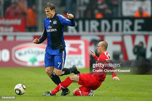 Miso Brecko of Köln and Marcell Jansen of Hamburg battle for the ball during the Bundesliga match between 1. FC Koeln and Hamburger SV at the...