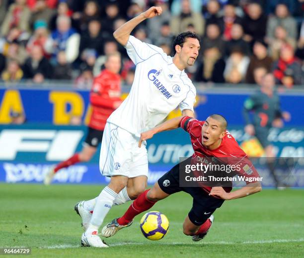 Du-Ri Cha of Freiburg battles for the ball with Kevin Kuranyi of Schalke during the Bundesliga match between SC Freiburg and FC Schalke 04 at...