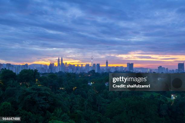 view of majestic sunrise over kl tower and surrounded buildings in downtown kuala lumpur, malaysia. - shaifulzamri - fotografias e filmes do acervo