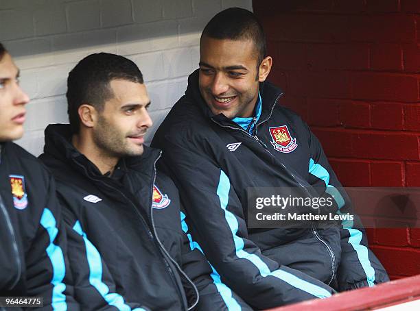 Ilan and Mido of West Ham United look on from the bench during the Barclays Premier League match between Burnley and West Ham United at Turf Moor on...