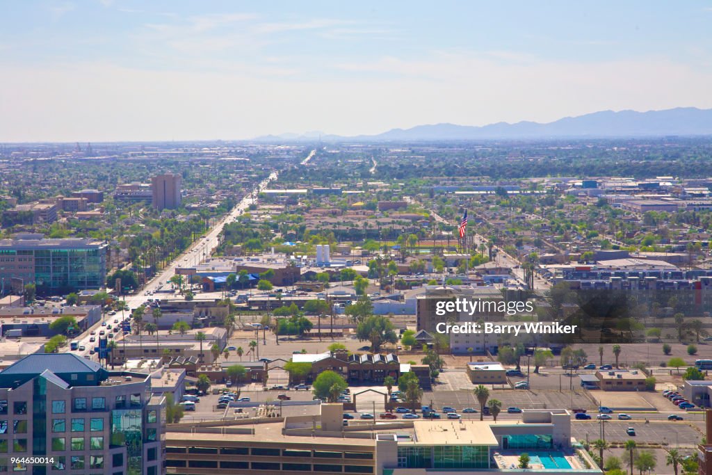 View from high up of downtown Phoenix street grid extending to the mountains