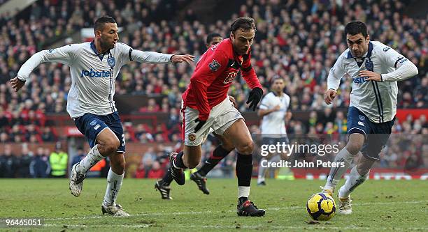 Dimitar Berbatov of Manchester United clashes with Nadir Belhadj and Ricardo Rocha of Portsmouth during the FA Barclays Premier League match between...