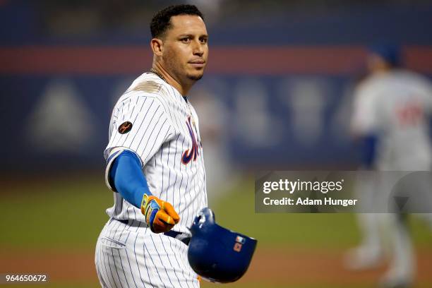 Asdrubal Cabrera of the New York Mets throws his batting helmet after flying out against the Chicago Cubs during the eighth inning at Citi Field on...