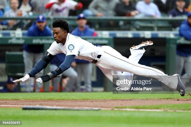 Dee Gordon scores on a sacrifice fly by Jean Segura of the Seattle Mariners in the first inning against the Texas Rangers during their game at Safeco...