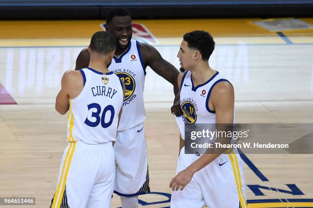 Draymond Green of the Golden State Warriors celebrates with Stephen Curry and Klay Thompson against the Cleveland Cavaliers in Game 1 of the 2018 NBA...