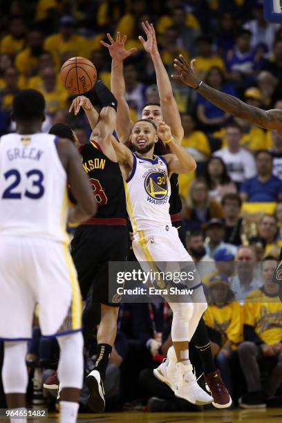 Stephen Curry of the Golden State Warriors attempts to pass around LeBron James, Jordan Clarkson and Larry Nance Jr. #22 of the Cleveland Cavaliers...