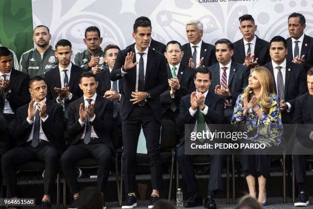 Mexican national soccer team captain Rafael Marquez waves next to President Enrique Pena Nieto during a send-off ceremony at the Los Pinos...