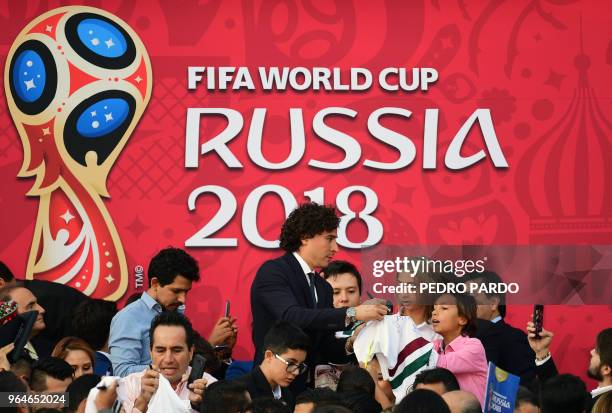 Mexican national football team player Guillermo Ochoa signs autographs, after a send-off ceremony at the Los Pinos presidential residence in Mexico...