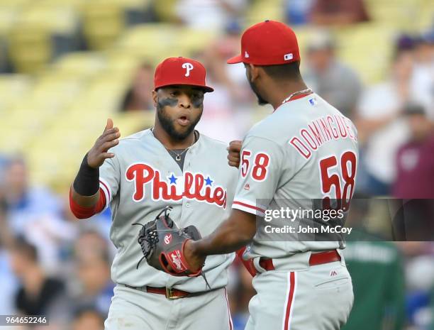 Carlos Santana of the Philadelphia Phillies congratulates pitcher Seranthony Dominguez after defeating the Los Angeles Dodgers 2-1 at Dodger Stadium...