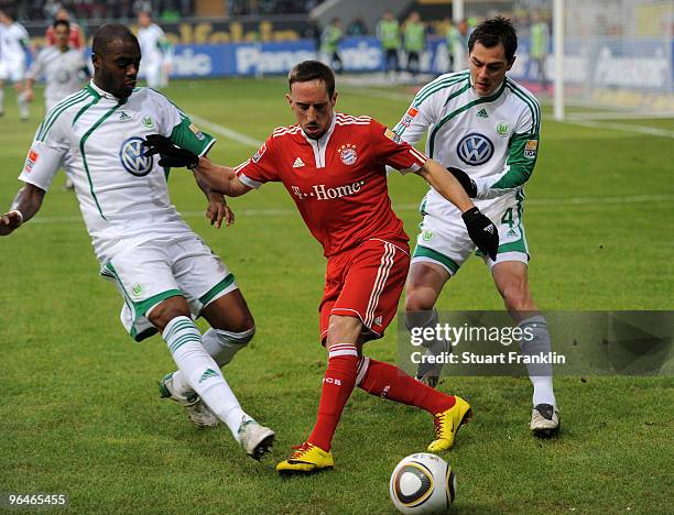 Franck Ribery of Muenchen is challenged by Grafite and Marcel Schaefer of Wolfsburg during the Bundesliga match between Vfl Wolfsburg and FC Bayern...