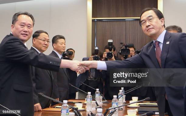 South Korean Unification Minister Cho Myoung-gyon shakes hands with the head of North Korean delegation Ri Son-Gwon during their meeting on June 1,...