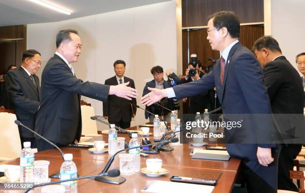 South Korean Unification Minister Cho Myoung-gyon shakes hands with the head of North Korean delegation Ri Son-Gwon during their meeting on June 1,...