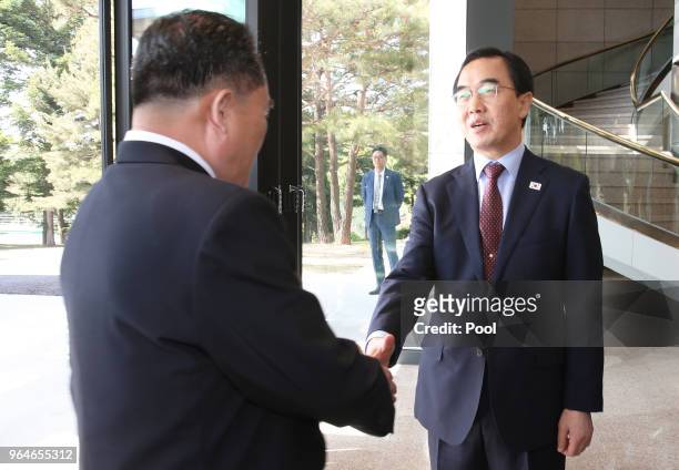 South Korean Unification Minister Cho Myoung-gyon shakes hands with the head of North Korean delegation Ri Son-Gwon before their meeting on June 1,...