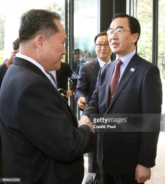 South Korean Unification Minister Cho Myoung-gyon shakes hands with the head of North Korean delegation Ri Son-Gwon before their meeting on June 1,...