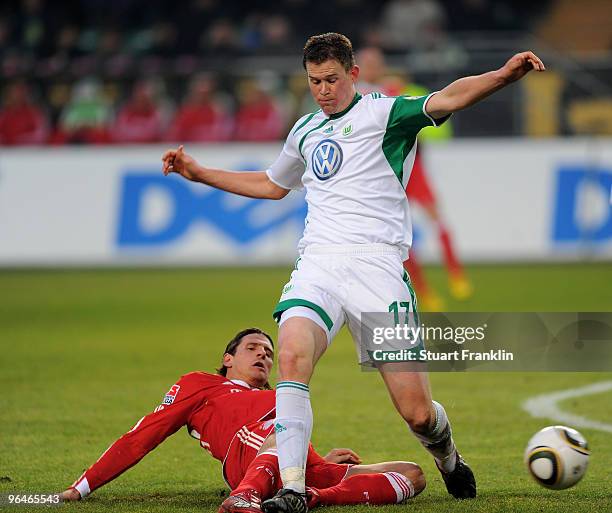 Mario Gomez of Muenchen is challenged by Alexander Madlung of Wolfsburg during the Bundesliga match between Vfl Wolfsburg and FC Bayern Muenchen at...