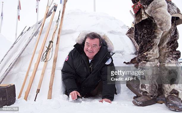 Canada's Finance Minister Jim Flaherty sucessfully exits an igloo outside the Nunavut legislature in Iqaluit, Canada during a break in proceedings at...