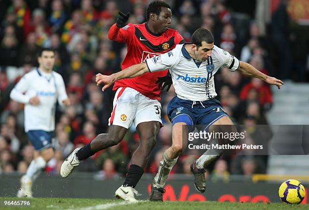 Mame Biram Diouf of Manchester United clashes with Tal Ben Haim of Porstmouth during the FA Barclays Premier League match between Manchester United...