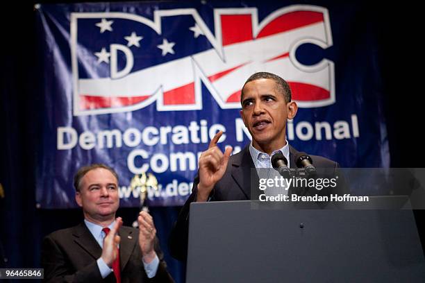 President Barack Obama receives applause from Democratic National Committee chairman Tim Kaine as he delivers remarks at the DNC winter meeting on...