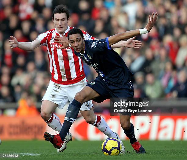 Steven N'Zonzi of Blackburn Rovers holds off a challenge from Dean Whitehead of Stoke City during the Barclays Premier League match between Stoke...