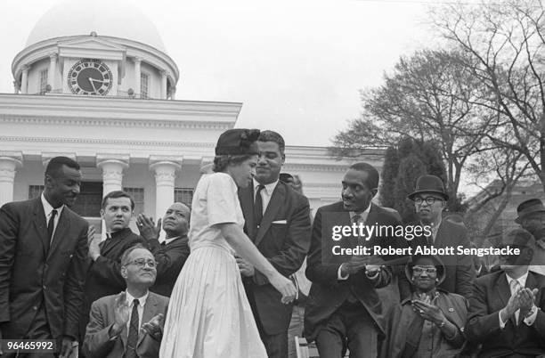 Civil rights pioneer Rosa Parks receives a round of applause from fellow civil rights leaders and supporters as she walks across the stage at a...