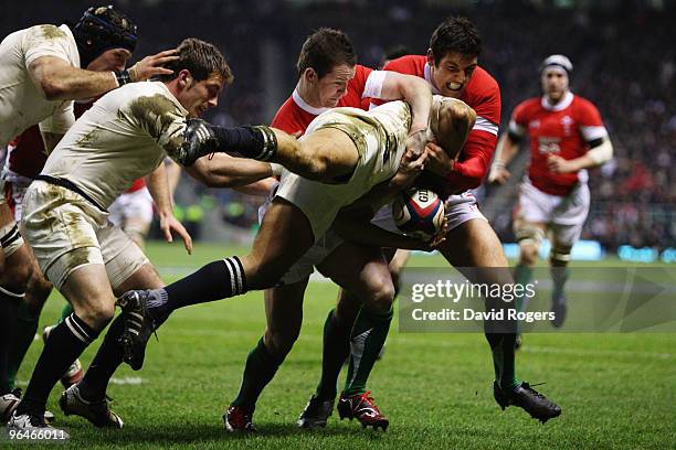 Jonny Wilkinson of England is tackled off the ground by Shane Williams and James Hook of Wales during the RBS 6 Nations Championship match between...