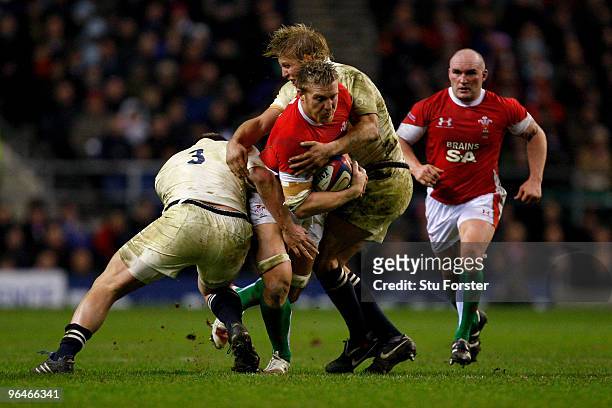 Andy Powell of Wales is tackled by David Wilson and Lewis Moody of England during the RBS 6 Nations Championship match between England and Wales at...