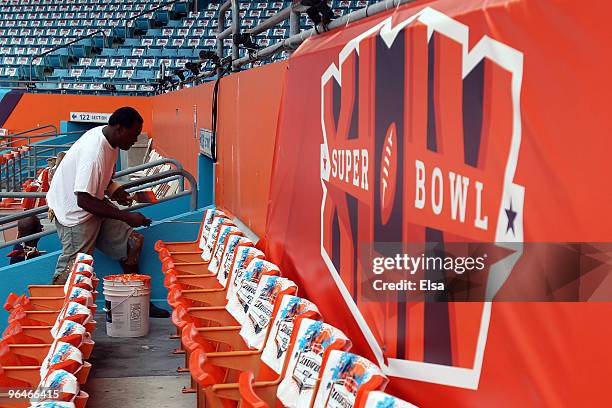 Stadium worker Tony Simms paints the wall inside Sun Life Stadium on February 6, 2010 in Miami Gardens, Florida. Sun Life Stadium will host Super...