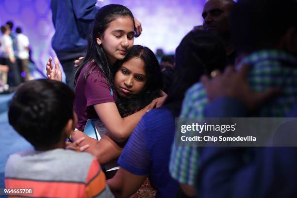 Naysa Modi embraces her mother before the final round of the 91st Scripps National Spelling Bee at the Gaylord National Resort and Convention Center...