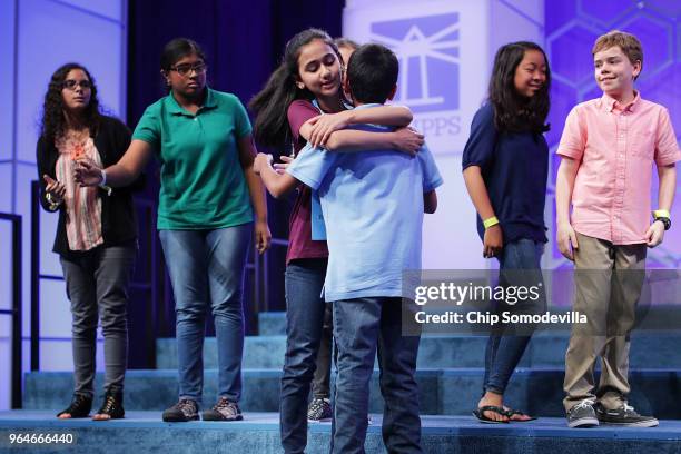 Naysa Modi embraces fellow competitor Abhijay Kodali after he misspelled the word 'aalii' the final round of the 91st Scripps National Spelling Bee...
