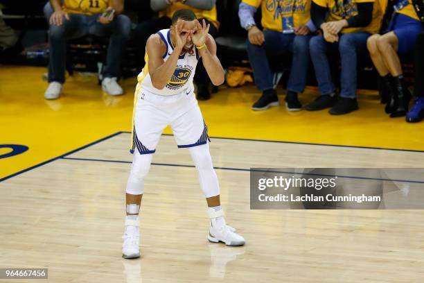 Stephen Curry of the Golden State Warriors celebrates against the Cleveland Cavaliers in overtime during Game 1 of the 2018 NBA Finals at ORACLE...