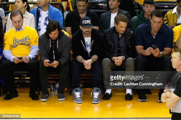 Maroon 5 members Matt Flynn and Adam Levine and life coach Tony Robbins look on from the stands in Game 1 of the 2018 NBA Finals between the Golden...