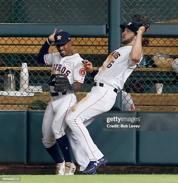 Jake Marisnick of the Houston Astros nearly collides with Tony Kemp as he makes a catch on a fly ball off the bat of Blake Swihart of the Boston Red...