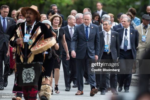 Bill Morneau, Canada's minister of finance, left, Stephen Poloz, governor of the Bank of Canada, fourth right, and Haruhiko Kuroda, governor of the...