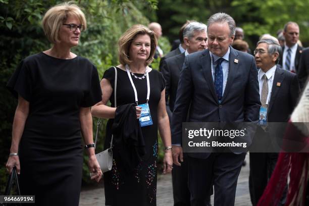 Stephen Poloz, governor of the Bank of Canada, front right, and his wife Valerie Poloz, front center, arrive for a dinner at the G7 finance ministers...