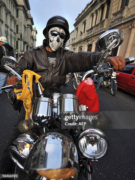 Motorcycle rider takes part in the caravan known as "La Caravana del Zorro" before heading out of Guatemala City on their way to Esquipulas on...
