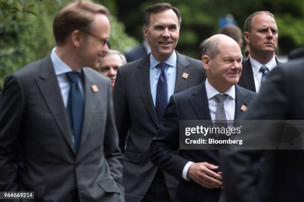 Jens Weidmann, president of the Deutsche Bundesbank, left, Bill Morneau, Canada's minister of finance, center, and Olaf Scholz, Germany's finance...