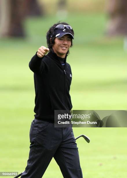 Ryo Ishikawa of Japan pumps his fist after his holing out from 120 yards out for an eagle on the par five 17th hole during the continuation of the...