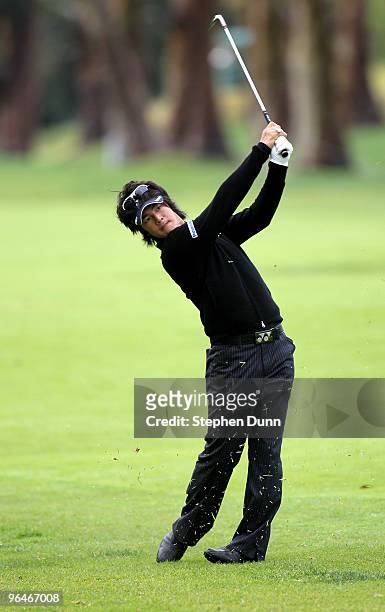 Ryo Ishikawa of Japan hits his third shot on th the par five 17th hole to hole out from 120 yards out for an eagle during the continuation of the...
