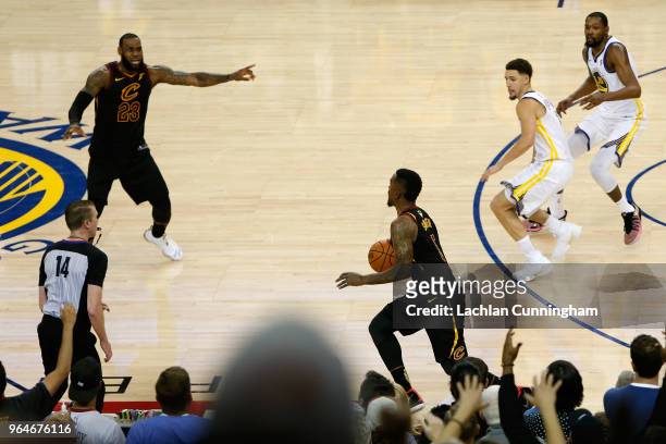 Smith of the Cleveland Cavaliers dribbles in the closing seconds of regulation as LeBron James attempts direct the offense against the Golden State...