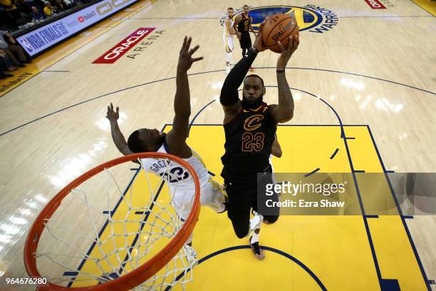 LeBron James of the Cleveland Cavaliers attempts a layup over Draymond Green of the Golden State Warriors in Game 1 of the 2018 NBA Finals at ORACLE...