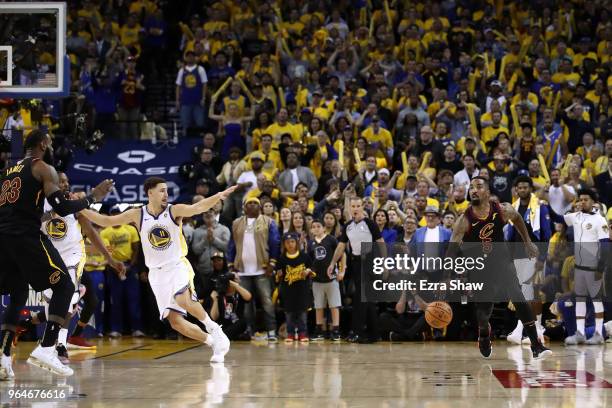 Smith of the Cleveland Cavaliers dribbles in the closing seconds of regulation as LeBron James attempts direct the offense against the Golden State...