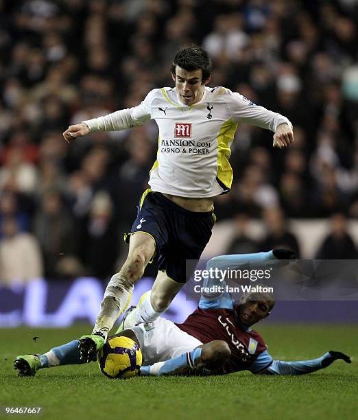 Gareth Bale of Tottenham Hotspur is tackled by Ashley Young of Aston Villa during the Barclays Premier League match between Tottenham Hotspur and...